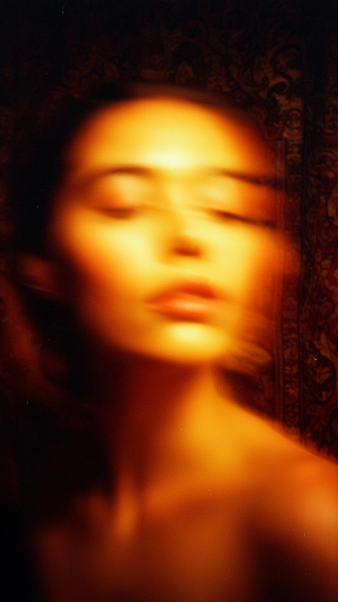 Cinematic warm-lit portrait of a woman bathed in golden light